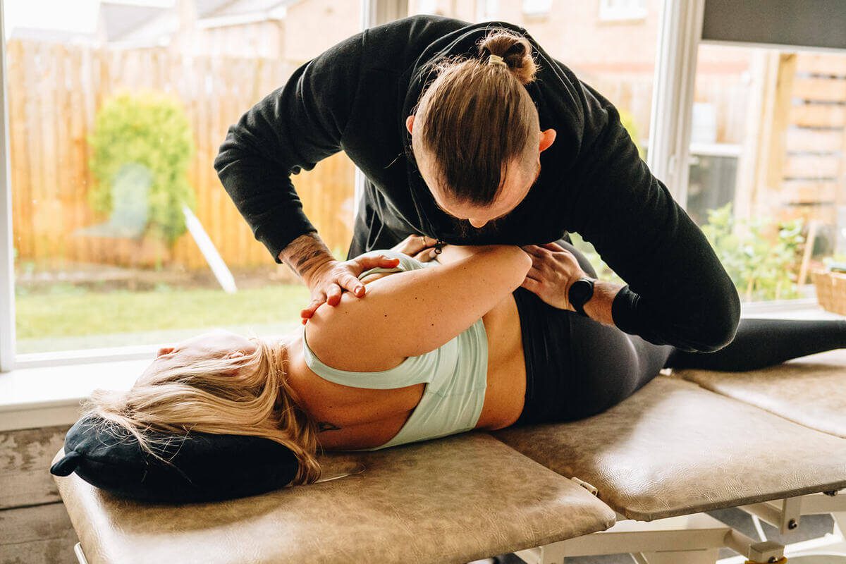 Physiotherapist performing a back adjustment on a patient in Glasgow clinic