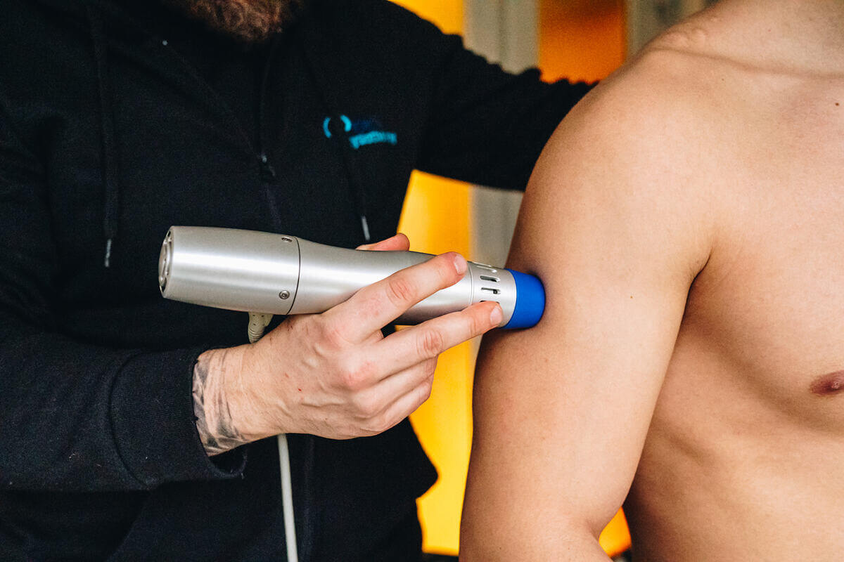 Glasgow physiotherapist administering shockwave therapy for precision pain relief